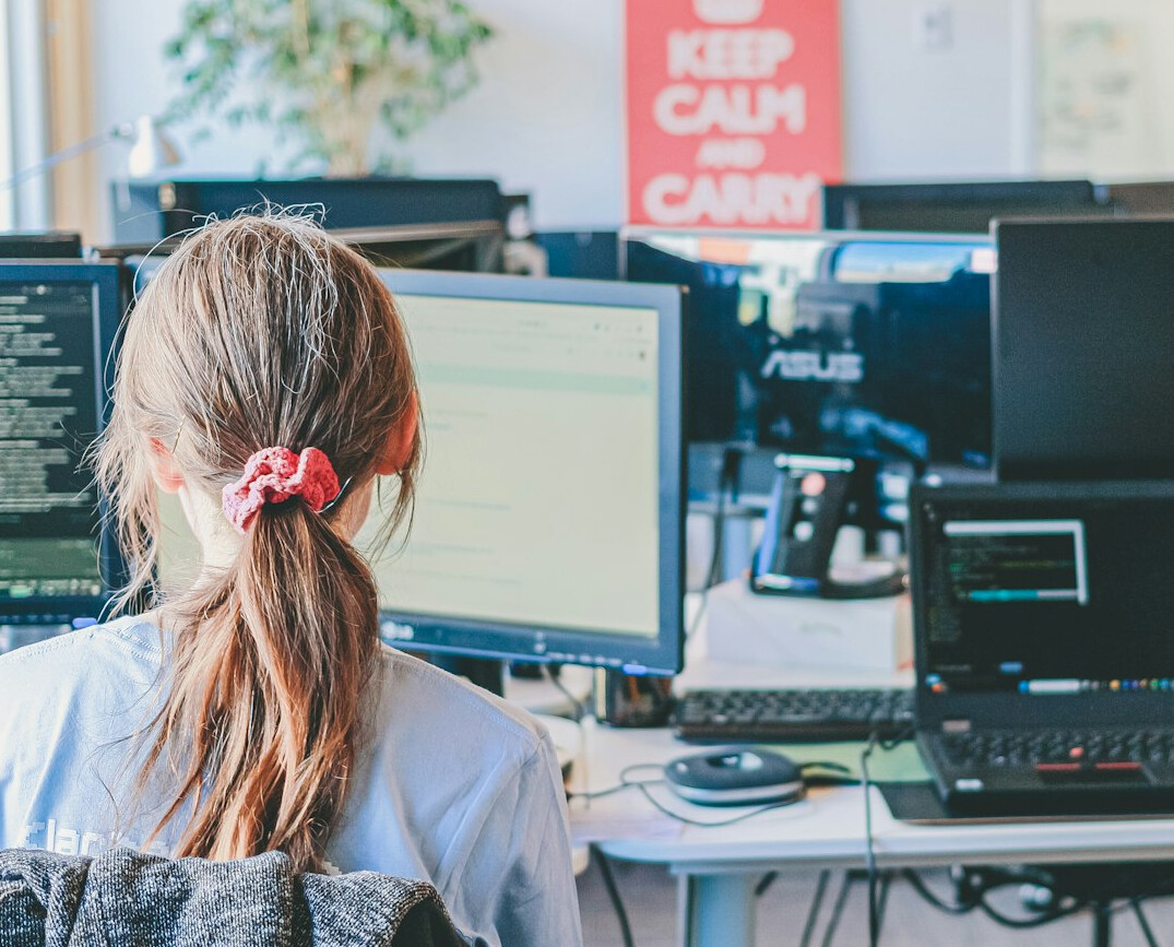 person coding at desk